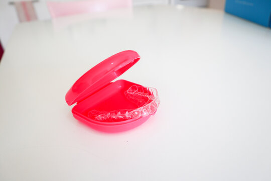 Clear aligners to straighten teeth for adults and teenagers with pink case