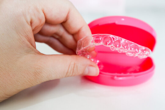 Clear aligners to straighten teeth for adults and teenagers with pink case