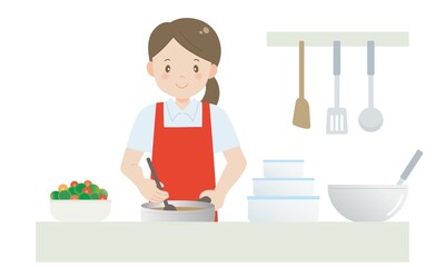 キッチンで料理をするエプロン姿の女性