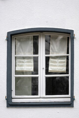 old window in white building