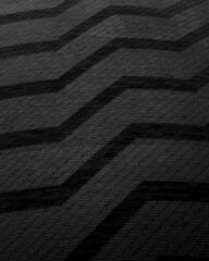 Vertical black and gray image with thick and thin zigzag figures