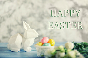 Congratulatory picture with a white Easter bunny and a basket of eggs. Lettering Happy Easter