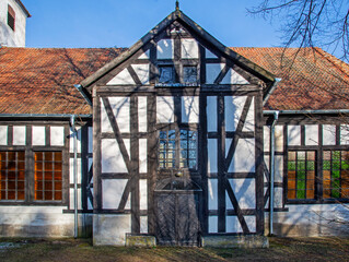 Obraz premium General view and close-up of architectural details of the post-Evangelical, now Catholic, historic church of Christ the King built in 1734 in the town of Jerutki in Masuria, Poland.