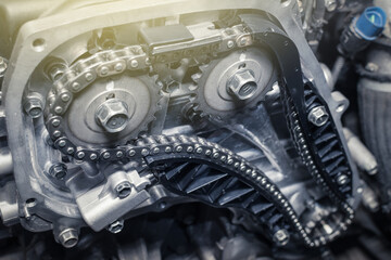 New car timing chain on a diesel old engine in a car workshop. Close up. Blur effect.