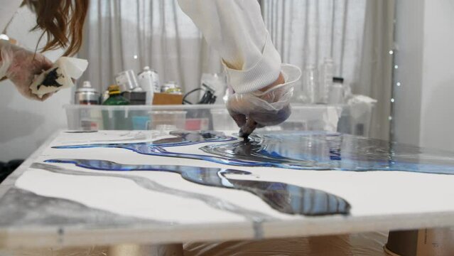 Drawing design with blue epoxy resin using fingers