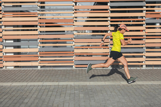 A Latina woman running in a race. Healthy living. female runner.