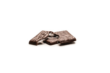 Dark chocolate candies isolated on white background.