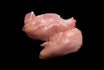 Raw chicken fillet isolated on a black background.