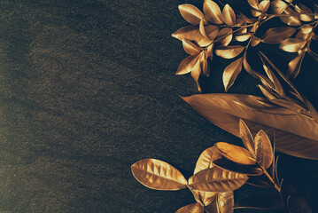 group of golden leaves on dark brick wall background