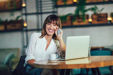 Young woman sitting in cafeteria and perform online shopping