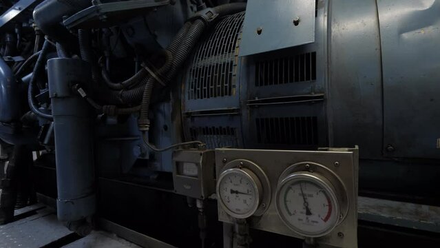 Next to diesel generator in engine room of ship