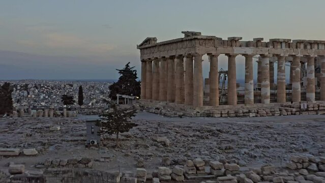 Athens Greece Aerial v32 low level fly around close up shot of ancient ruins of greek parthenon located in city of athens with majestic golden sunset and cityscape in the background - September 2021