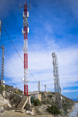 telecommunication masts with mobile phone antennas on the blu sky