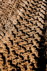 Tyre track on dirt sand or mud, Picture in retro or grunge tone. Car drive on sand. off road track. Track on grass field. Track in farm.	