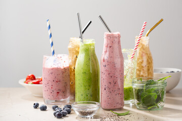 Vegan berry fruit spinach smoothie in bottles glass