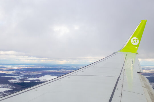 Airplane wing S7 in the air in flight above the ground. Travel and tourism. Moscow, Russia-20.02.2022