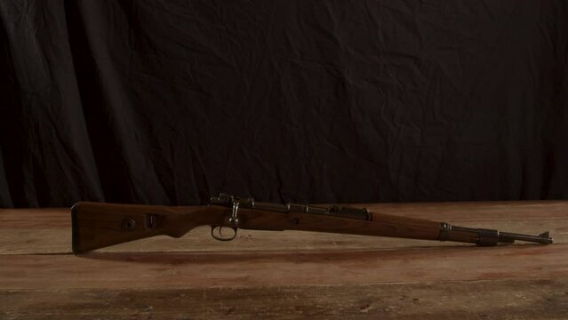 Wide dolly old K98 Mauser rifle standing on a wooden surface