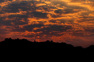sunset over the mountains with beautiful clouds