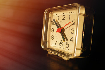 Vintage analog clock during sunset background