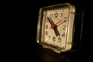 Vintage analog clock during sunset backdrop