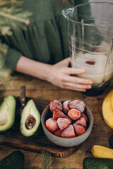 A cup of frozen berries prepared for a smoothie