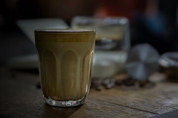 clear cup of coffee put on brown wooden table.