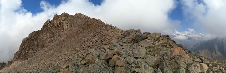 Clouds touch the mountain rocks