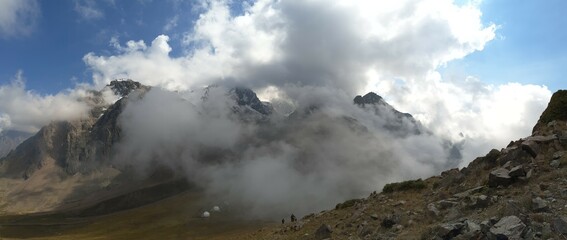 Clouds touch the mountain rocks