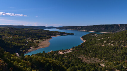 Fototapeta na wymiar Beautiful panoramic view of reservoir Lake of Sainte-Croix located west of Verdon Gorge in Provence region, France with bridge Pont du Galetas.