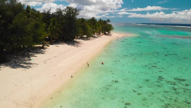 Aerail footage of Aroa Beach in the Rarotonga in the Cooks island in the southern Pacific. Shot with a backward motion