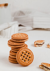 Sweet sandwich cookies with chocolate filling on a white table. Breakfast concept.