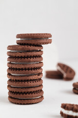 Stack of chocolate sandwich cookies close up. Cookies with cream filling.