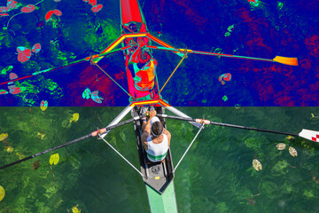 Real and Thermal image of two rowers in a boat, rowing on the tranquil lake - obrazy, fototapety, plakaty