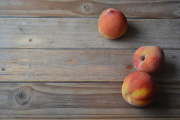 fresh peaches on wooden background