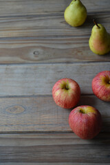 fresh apples and pears on wooden background