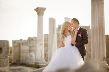 Kiss of the newlyweds after the wedding. Against the background of beautiful bright nature. Happy wedding photo of the bride and groom at the wedding ceremony. Wedding traditions, husband and wife. 