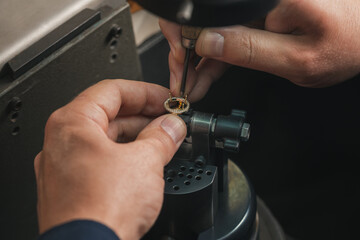 Goldsmith at work. Jeweler's workbenche with different tools. Desktop for craft jewelry making with professional tools.