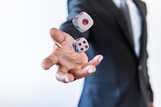 Business man throwing the dices gambling game in hand concept