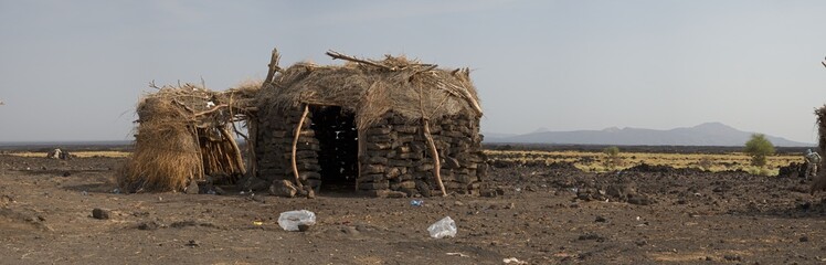 Landscape panorama view of traditional houses in front of Erta Ale Volcano in the remote regions of Ethiopia.