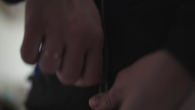 young Spanish woman buckling up her sports jacket for a run.