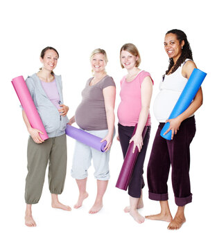 Heading out for their lamaze class. Pregnant friends standing together and holding their yoga mats while isolated on white.