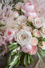 Wedding flowers, bridal bouquet closeup. Decoration made of roses, peonies and decorative plants, close-up, selective focus, nobody, objects. Wedding day.