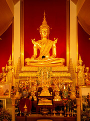 Ubon Ratchathani, Thailand, January 30, 2022: Buddhists admire the beauty of Buddha images at Wat Pa Phu Pang, Sri Chiang Mai, Ubon Ratchathani Province, Thailand.