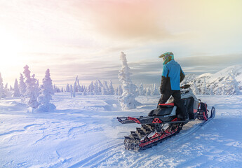 travel on a modern mountain snowmobile against the backdrop of beautiful mountain valleys after a...