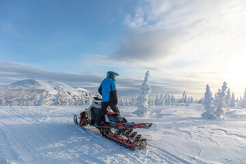 travel on a modern mountain snowmobile against the backdrop of beautiful mountain valleys after a...
