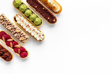 Cupcakes eclairs with pistachio raspberries and chocolate cream topping