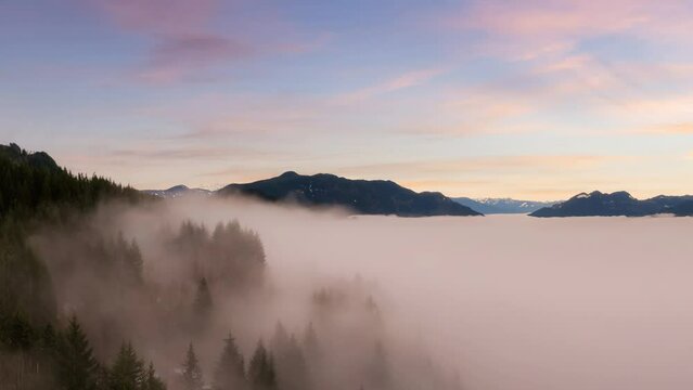 Cinemagraph Loop Animation. Aerial Panoramic View of Canadian Mountain Landscape covered in fog over Harrison Lake. Dramatic Colorful Winter Sunset Sky Art Render. British Columbia, Canada.