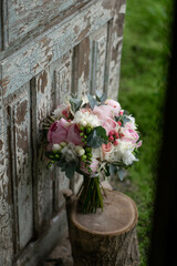 Pink wedding bouquet, composed of roses, freesias, peonies, hypericum, astilba and eucalypthus.