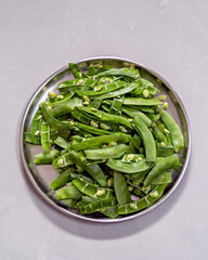 Freshly pre-cut beans vegetables arranged in a plate for cooking preparations in home