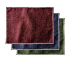 stacked of velvet fabric samples in red, blue and green color isolated on background with clipping...